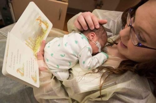 mum reading to baby in nicu